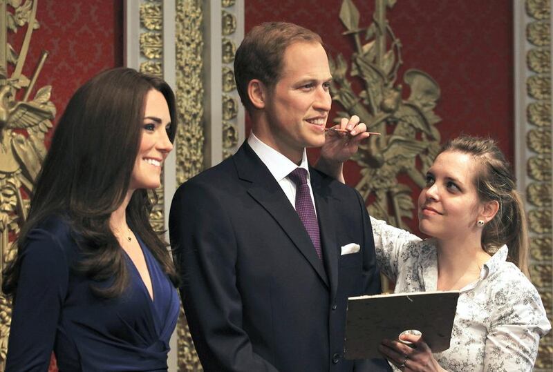 A gallery assistant attends waxwork models of Britain’s Prince William and his wife Catherine, Duchess of Cambridge, at Madame Tussauds in London. Olivia Harris / Reuters