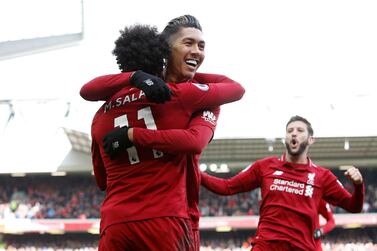 Soccer Football - Premier League - Liverpool v Burnley - Anfield, Liverpool, Britain - March 10, 2019 Liverpool's Roberto Firmino celebrates scoring their third goal with Mohamed Salah REUTERS/Andrew Yates EDITORIAL USE ONLY. No use with unauthorized audio, video, data, fixture lists, club/league logos or "live" services. Online in-match use limited to 75 images, no video emulation. No use in betting, games or single club/league/player publications. Please contact your account representative for further details.