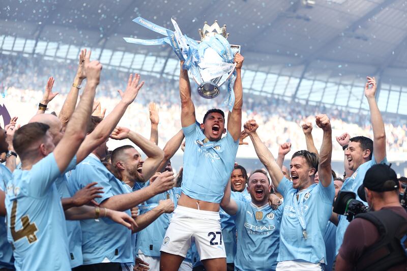 Matheus Nunes of Manchester City lifts the trophy. Getty Images