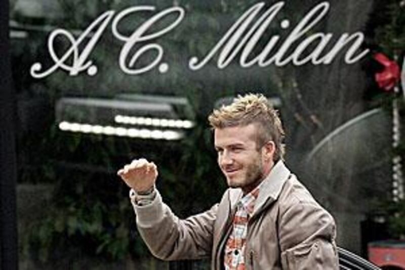 David Beckham gestures towards his fans as he arrives to the AC Milan sports centre, in Carnago, Itlay.