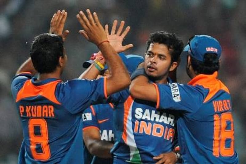 Indian cricketer Shanthakumaran Sreesanth celebrates with teammates after taking the wicket of unseen South African cricketer Roelof van der Merwe during the second One Day International (ODI) cricket match at the Captain Roop Singh Stadium in Gwalior on February 24, 2010. South Africa is currently 103 runs for the loss of six wickets chasing India's score of 401 runs.  FP PHOTO/ MANAN VATSYAYANA *** Local Caption ***  942708-01-08.jpg