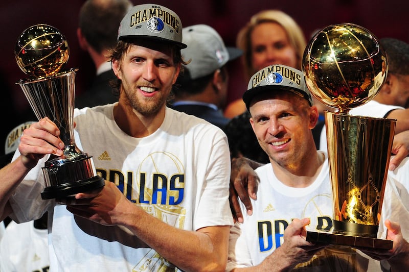 Dirk Nowitzki, left, and Jason Kidd, right. of the Dallas Mavericks hold the MVP and Larry O'Brien Trophies after defeating the Miami Heat in Game 6.