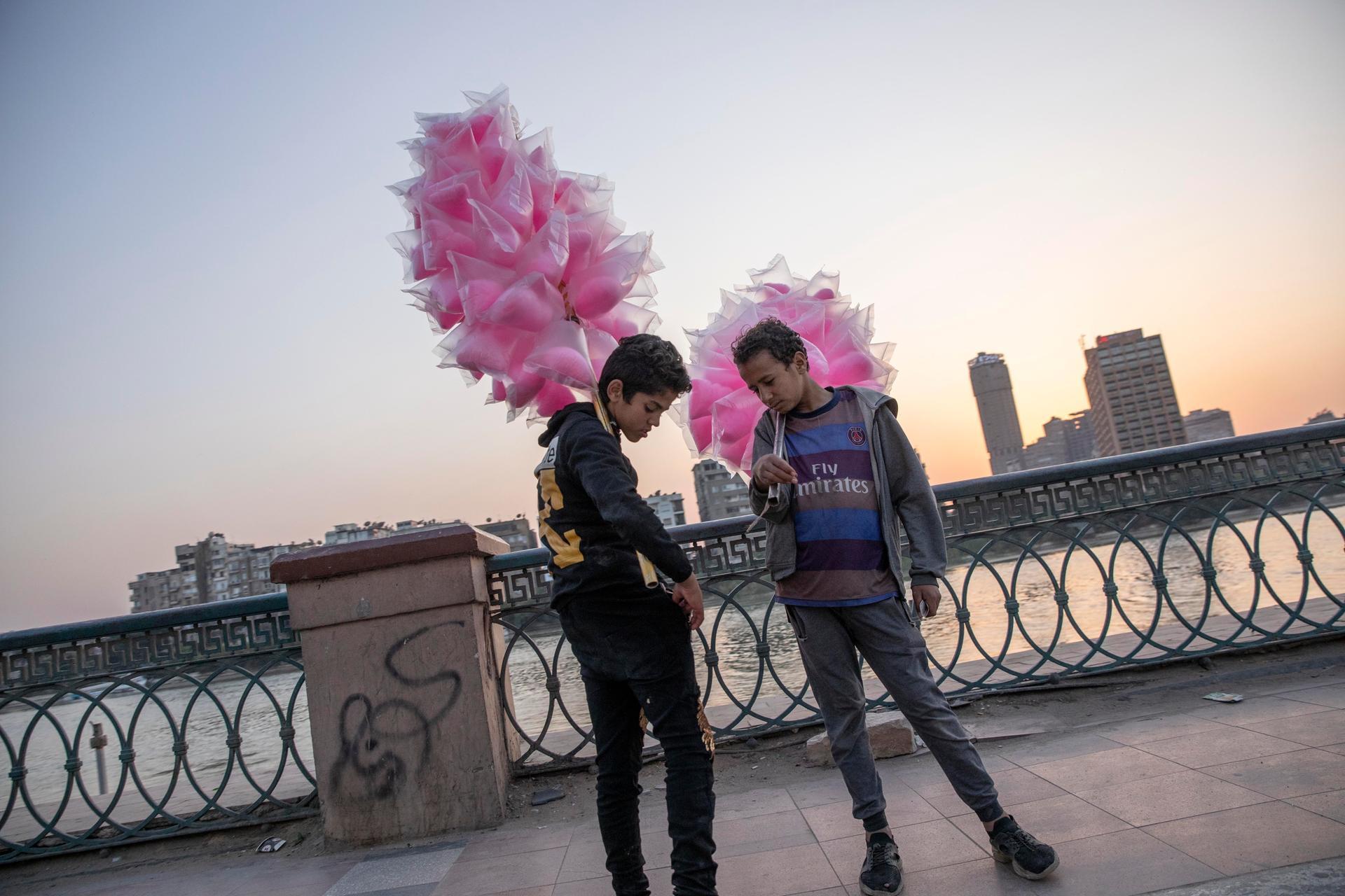 Boys sell cotton candy an hour ahead of the curfew imposed by the government as prevention measures due to the coronavirus outbreak, in Cairo, Egypt. AP Photo