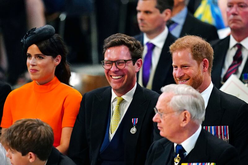 Princess Eugenie, her husband Jack Brooksbank and Prince Harry share a light-hearted moment at the service of thanksgiving. AP Photo