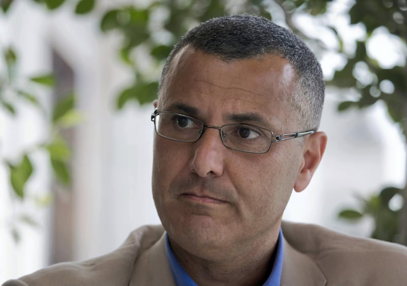 Omar Barghouti listens during an interview with the Associated Press in the West Bank city of Ramallah, Tuesday, May 10, 2016. Barghouti, a Qatari-born Palestinian who is married to an Israeli woman and leader of the international boycott movement against Israel, on Tuesday accused Israeli authorities of imposing a travel ban on him as retribution for his political activities. (AP Photo/Nasser Nasser)