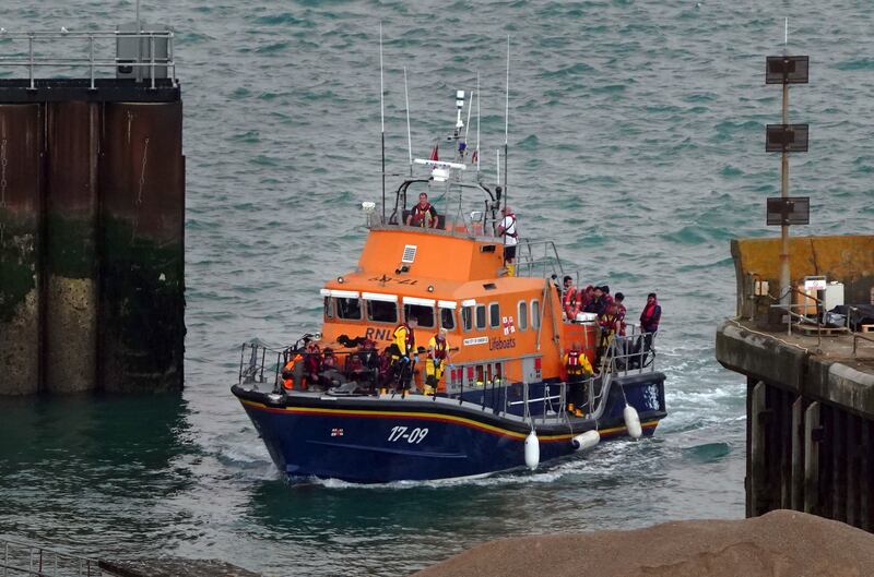 A group of people thought to be migrants are brought in to Dover, Kent. AP