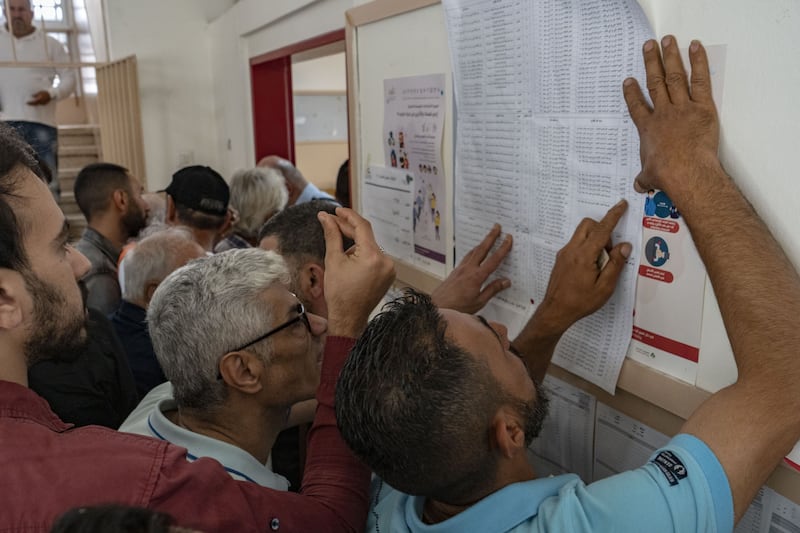 Voters look at a list of candidates at a polling station in Beirut. Bloomberg
