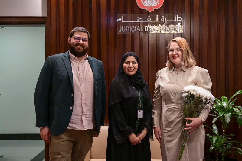 An Emirati court official smiles as the process is complete.
