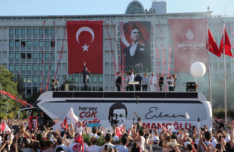 Mr Imamoglu addresses his supporters from the top of a bus outside the City Hall. Reuters