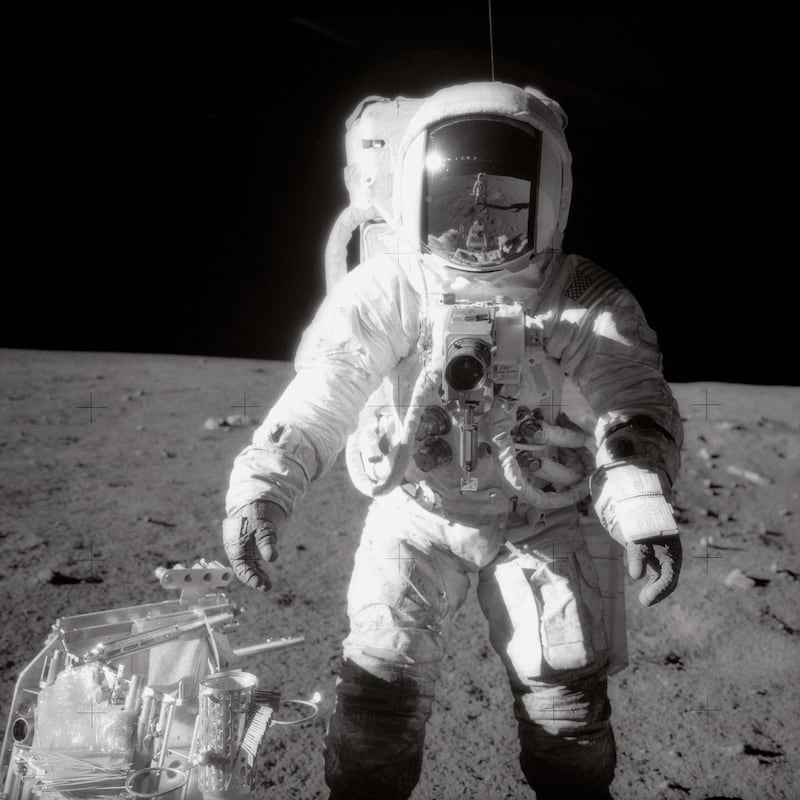 Astronaut Alan Bean, Lunar Module pilot, pausing near a tool carrier during the Apollo 12 spacewalk on the moon's surface. Commander Charles Conrad, Jr., who took the black-and-white photo, is reflected in Bean's helmet visor. Bean, who was the fourth person to walk on the moon, passed away on 26 May 2018 in Houston, Texas at the age of 86.  EPA