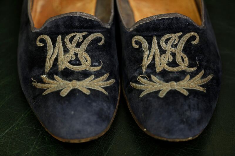 The slippers, which date back to the 1950s, feature Churchill's initials in golden thread. AP