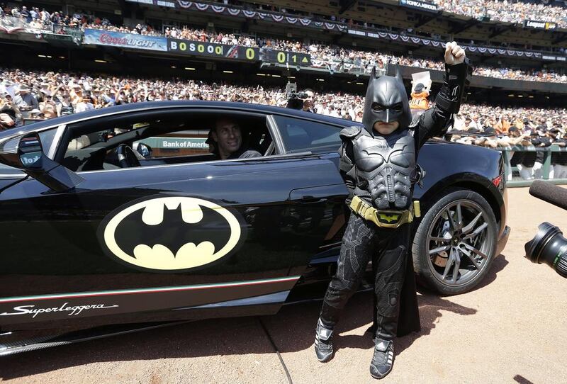 Miles Scott, dressed as Batkid, gestures as he exits the Batmobile to throw the ceremonial first pitch before the San Francisco Giants home opener against the Arizona Diamondbacks. Eric Risberg /AP