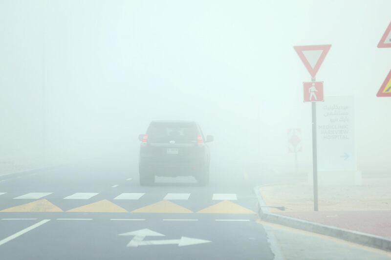 Dubai, United Arab Emirates - March 14, 2019: Parents take their children to school on a foggy morning in Dubai. Thursday the 14th of March 2019 in Al Barsha, Dubai. Chris Whiteoak / The National