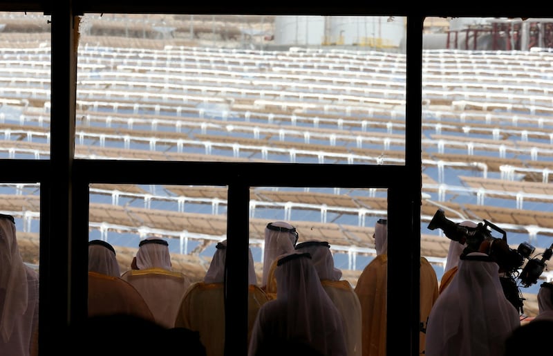 TO GO WITH STORY BY ALI KHALIL
UAE officials are seen from behind a glass door as they look from a balcony at the Shams 1, Concentrated Solar power (CSP) plant, in al-Gharibiyah district on the outskirts of Abu Dhabi, on March 17, 2013 during the inauguration of the facility. Oil-rich Abu Dhabi officially opened the world's largest Concentrated Solar Power (CSP) plant, which cost $600 million to build and will provide electricity to 20,000 homes. AFP PHOTO/MARWAN NAAMANI (Photo by MARWAN NAAMANI / AFP)