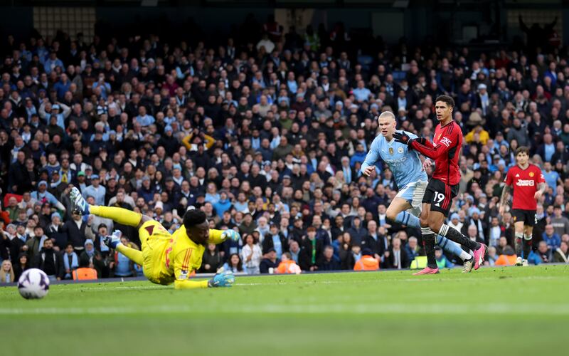  Erling Haaland of Manchester City scores his team's third goal past Manchester United keeper Andre Onana. Getty Images