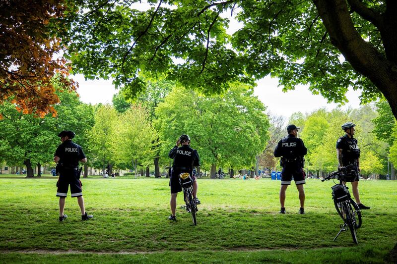 Toronto Police keep watch at Trinity Bellwoods Park as the province prepares for more phased re-openings from the coronavirus restrictions in Toronto, Ontario, Canada. Reuters