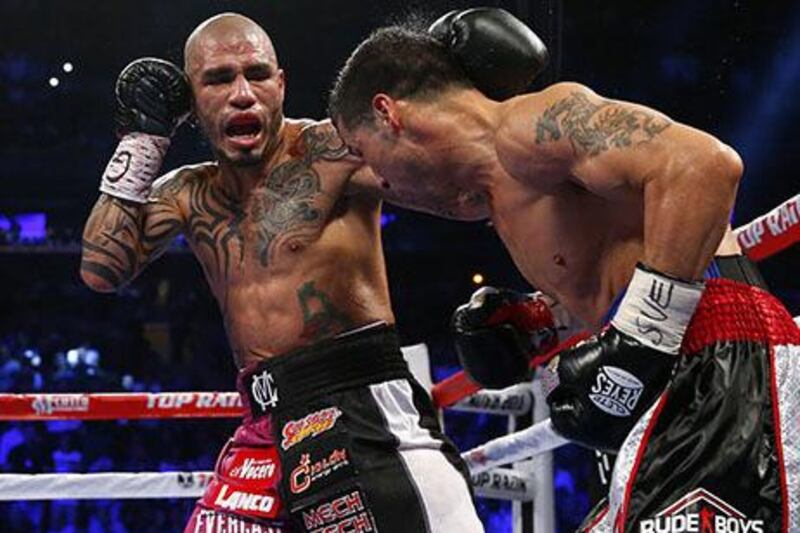 Miguel Cotto glances a left punch off the head of Sergio Martinez during the third round of the WBC Middleweight Championship fight at Madison Square Garden in New York City. Cotto won by a TKO in the ninth round. Rich Schultz / Getty Images