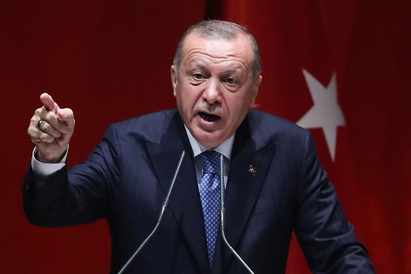 Turkey's President and leader of the AKP Justice and Development Party, Recep Tayyip Erdogan gestures as he speaks on stage during a party meeting at the AKP headquarters in Ankara, on July 26, 2019.  / AFP / Adem ALTAN
