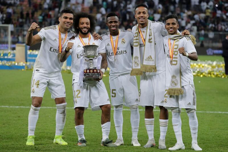 From left to right, Real Madrid's Casemiro, Real Madrid's Marcelo, Real Madrid's Vinicius Junior, Real Madrid's Eder Militao and Real Madrid's Rodrygo celebrate end the Spanish Super Cup Final soccer match between Real Madrid and Atletico Madrid at King Abdullah stadium in Jeddah, Saudi Arabia, Sunday, January 12, 2020. AP Photo/Hassan Ammar