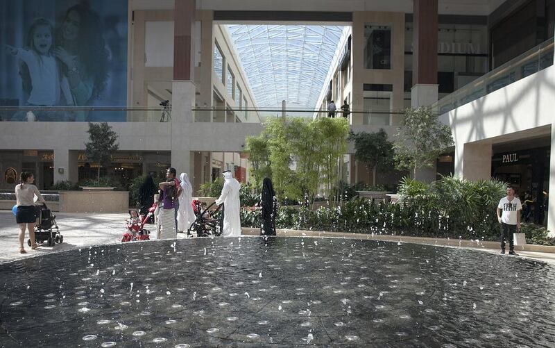 Shoppers walk through Yas Mall’s Town Centre on its opening day on Yas Island yesterday. Silvia Razgova / The National 
