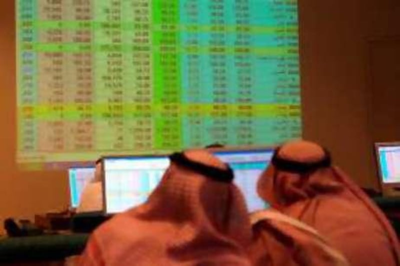 Saudi traders look at monitors showing the movement of the stock market at a bank in the Saudi capital Riyadh on April 15, 2008. AFP PHOTO/STR