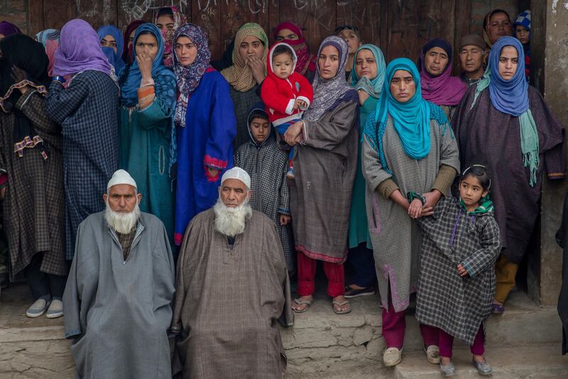 Villagers in Palhalan watch the funeral procession of Ashiq Ahmed Bhat, a local rebel killed in a gun battle,  in Indian controlled Kashmir. Dar Yasin / AP Photo
