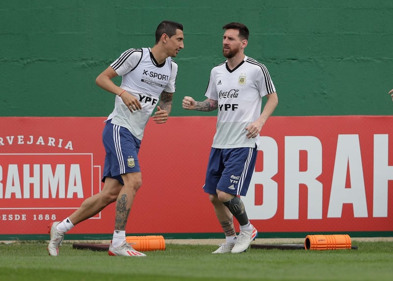 Messi and Angel Di Maria warm up. AP Photo