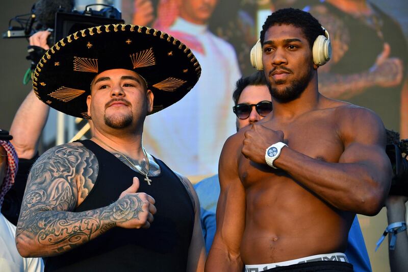 Mexican-American heavyweight boxing champion Andy Ruiz Jr (L) and British heavyweight boxing challenger Anthony Joshua pose during the official weigh-in at Diriyah in the Saudi capital Riyadh, on December 6, 2019, ahead of the upcoming "Clash on the Dunes".  The hotly-anticipated rematch between Ruiz Jr and British challenger Anthony Joshua is scheduled to take place in Diriya, near the Saudi capital on December 7. / AFP / Giuseppe CACACE
