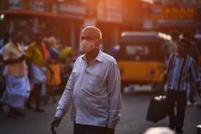 A pedestrian in Chennai wears a face mask amid a surge in Covid-19 cases in the south Indian city. EPA
