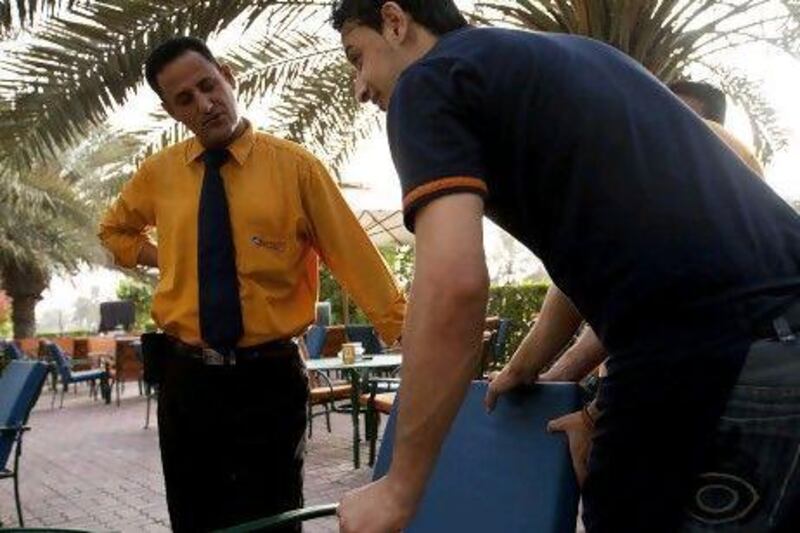 Egyptian expatriate Yahia Abdeljawad Almutwaili, 39, left, a waiter at Special Cafe in Abu Dhabi on May 25, 2012. Almutwaili voted in the Egyptian election and is not optimistic about the future of the country. Christopher Pike / The National