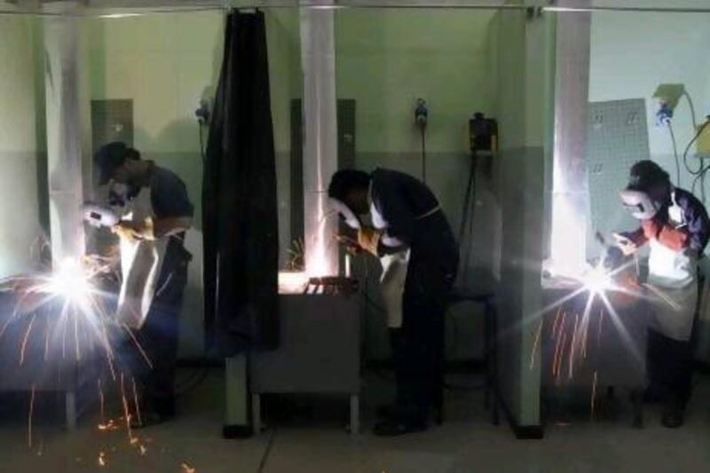 Students work at the welding and fitting workshop at VEDC Vocational Education Development Centre in Al Shahama.