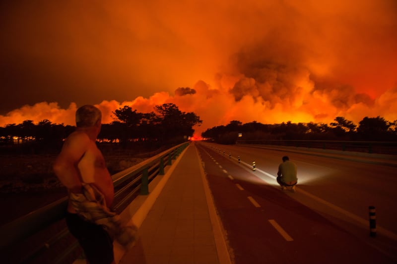 Residents look to the fire in Praia da Vieira, Marinha Grande, Portugal. Ricardo Graaia / EPA