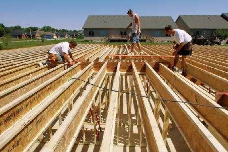 In this photograph taken June 30, 2010, construction workers build a new home in Springfield, Ill. Construction spending edged up in June but all the strength came from the government. Private sector activity in both housing and nonresidential projects fell.(AP Photo/Seth Perlman) *** Local Caption ***  ILSP204_Construction_Spending.jpg