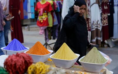 A woman walks past spices for sale at a market, in Aswan, southern Egypt. AP