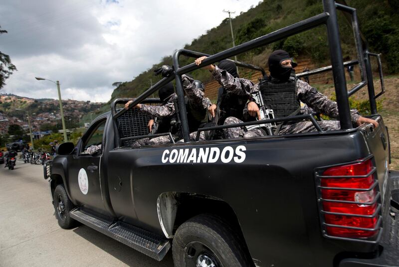 Members of the Venezuelan Bolivarian Intelligence Service arrive to the Junquito highway during an operation to capture Oscar Perez, according to officials, in Caracas, Venezuela, Monday, Jan. 15, 2018. Venezuelan special forces exchanged gunfire Monday with the rebellious police officer who has been on the run since leading a high-profile attack in Caracas last year, officials said. (AP Photo/Fernando Llano)