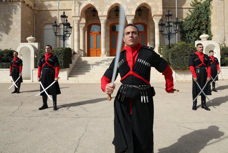 The guards still adhere to their ancient traditions and adorn Circassian costume and train with swords and horses
