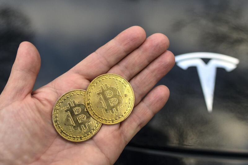 Illustrative image of two commemorative bitcoins seen in front of the Tesla car logo.
On Saturday, February 27, 2021, in Dublin, Ireland. (Photo by Artur Widak/NurPhoto via Getty Images)