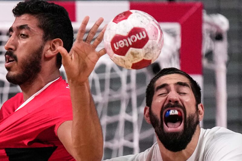 France's Nikola Karabatic, right, and Egypt's Yahia Omar challenge for the ball.