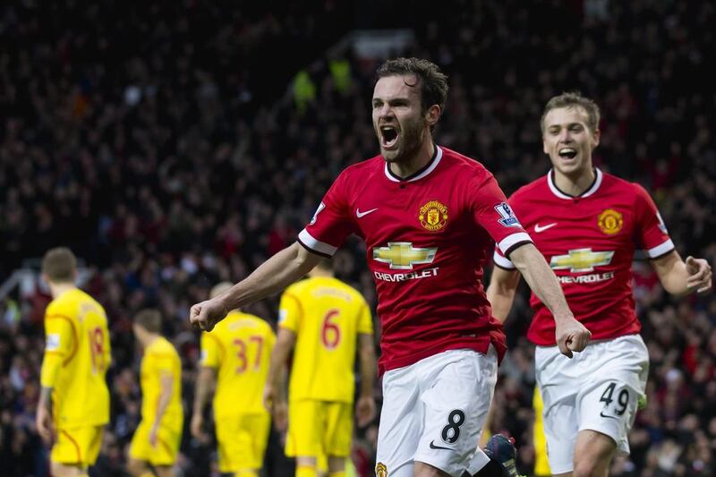 Manchester United's Juan Mata celebrates after scoring against Liverpool on Sunday in the Premier League. Jon Super / AP