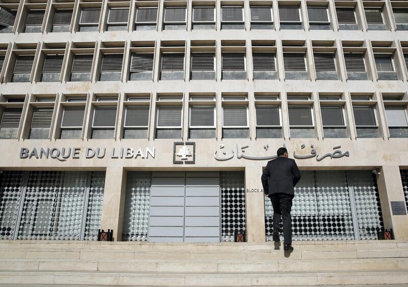 FILE - This Tuesday, Jan. 22, 2019 file photo, a man heads to the Lebanese central bank, in Beirut, Lebanon. The Beirut Stock Exchange said Monday, May 6, 2019, that it is suspending trading due to the open strike declared by the employees of Lebanon's central bank. Hundreds of Lebanese public employees are on strike amid concerns that their salaries and benefits might be cut as the government discusses an austerity budget. (AP Photo/Hussein Malla, File)