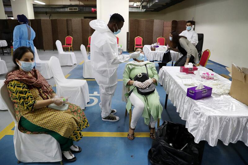 DUBAI, UNITED ARAB EMIRATES , Feb 6 – PEOPLE TAKING THE PCR TEST BEFORE GETING THE FIRST DOSE OF SINOPHARM VACCINATION DURING THE VACCINATION DRIVE AT THE GURU NANAK DARBAR GURUDWARA IN DUBAI. Guru Nanak Darbar Gurudwara has partnered with Tamouh Health Care LLC, to provide on-site Sinopharm Vaccination for all residents of the UAE free of charge on 6th, 7th & 8th February 2021. (Pawan Singh / The National) For News/Online