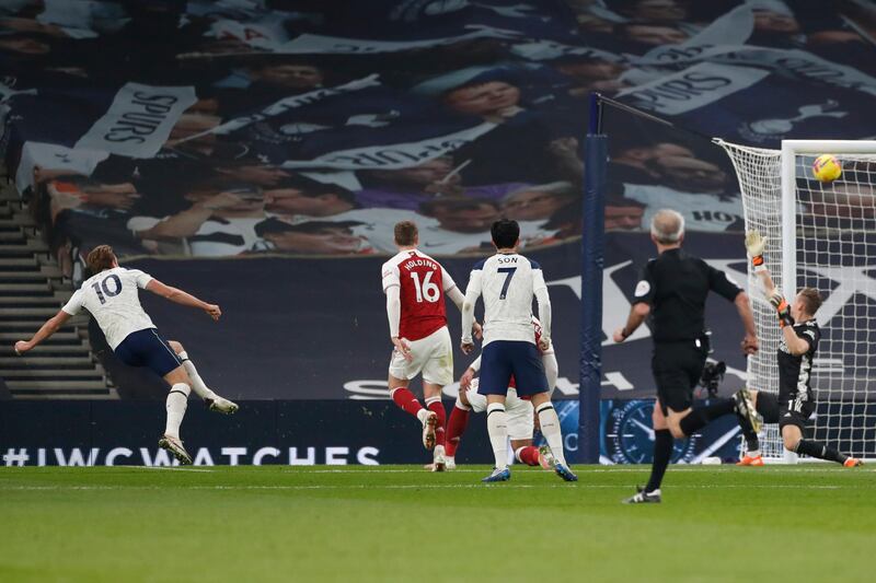Tottenham's Harry Kane, left, scores his side's second goal past Arsenal's goalkeeper Bernd Leno. AP