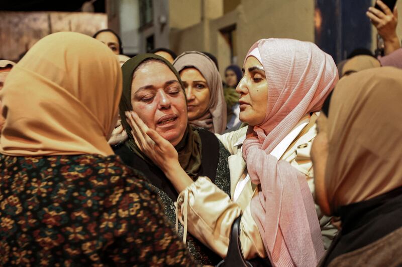 Mourners comfort the mother of Mohammed Badarneh, a 25-year-old Palestinian killed during protests as Israeli forces raided the West Bank town of Yabad on November 30. AFP