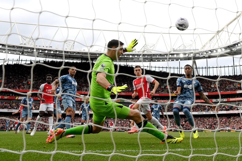 Aston Villa goalkeeper Emiliano Martinez makes a save from Leandro Trossard of Arsenal. Getty Images