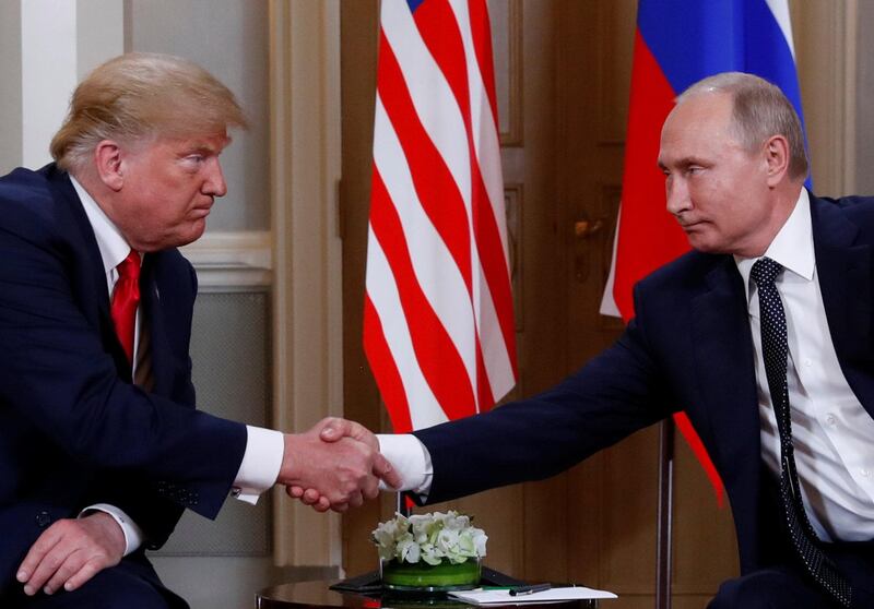 Donald Trump and Vladimir Putin shake hands as they meet in Helsinki. Reuters