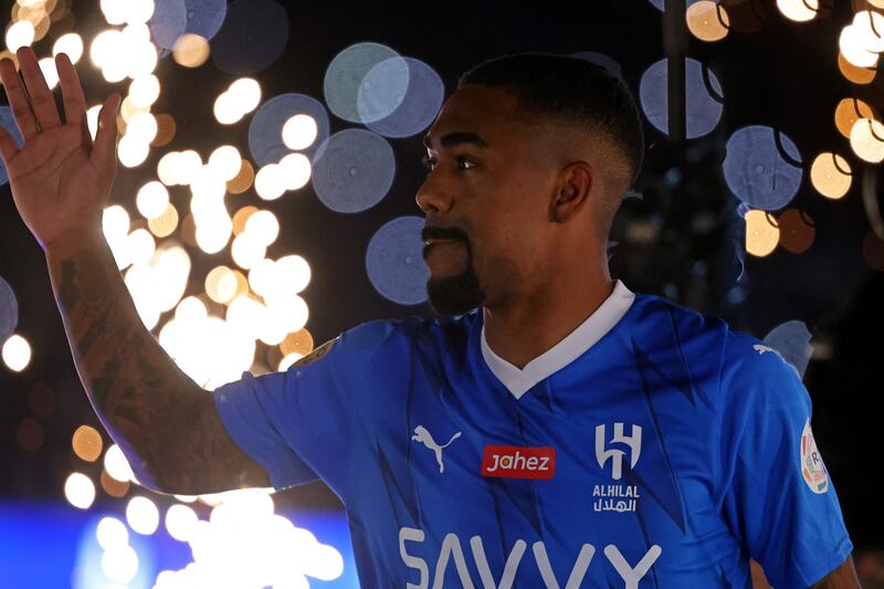 Brazilian forward Malcom greets fans as he enters the pitch during his unveiling. AFP
