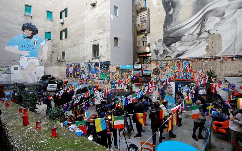 People gather on the streets of Naples to mourn the death of Diego Maradona. Reuters