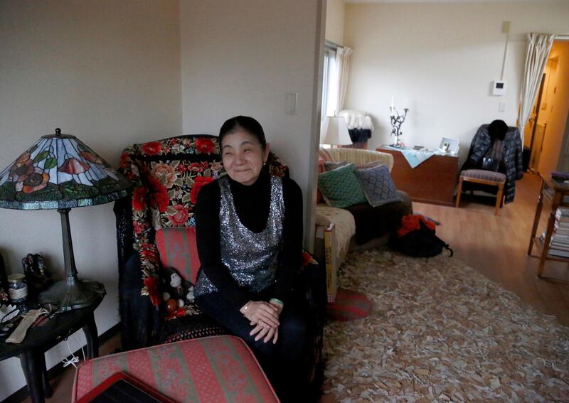 In this March 7, 2018, photo, retired harpist Yumi Makino sits in her apartment room in Tokyo. Makino won a two-year legal battle to get out of a senior citizens home she hated and get her deposit money back in a rare victory over a big real estate company. Her  experience reflects the challenges many older Japanese face in finding suitable care and accommodations in â€œsuper-agingâ€ Japan, the worldâ€™s No. 1 aging nation. (AP Photo/Yuri Kageyama)