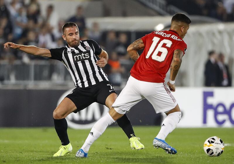 Marcos Rojo is challenged by Zoran Tosic at the Partizan Stadium. Getty Images