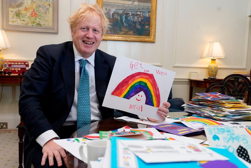 (FILES) In this handout file photo taken and released on April 28, 2020 by 10 Downing Street, Britain's Prime Minister Boris Johnson is seen displaying his Get Well Soon cards sent in by children while he was ill with the novel coronavirus COVID-19, at his office in 10 Downing Street, central London. Doctors treating Boris Johnson for coronavirus prepared to announce his death after he was taken to intensive care, the British prime minister said on Sunday, May 3, in his first detailed comments about his illness. - RESTRICTED TO EDITORIAL USE - MANDATORY CREDIT "AFP PHOTO / 10 DOWNING STREET / ANDREW PARSONS" - NO MARKETING - NO ADVERTISING CAMPAIGNS - DISTRIBUTED AS A SERVICE TO CLIENTS
 / AFP / 10 Downing Street / Andrew PARSONS / RESTRICTED TO EDITORIAL USE - MANDATORY CREDIT "AFP PHOTO / 10 DOWNING STREET / ANDREW PARSONS" - NO MARKETING - NO ADVERTISING CAMPAIGNS - DISTRIBUTED AS A SERVICE TO CLIENTS

